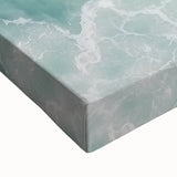 Vibrant close-up of a stretched canvas depicting a serene beach landscape, showcasing gentle waves and soft sand, perfect for coastal home decor.