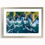 Silver-framed landscape artwork featuring dramatic cliffs, set against a vivid sky, elegantly matted for enhanced presentation, perfect for home decor.