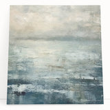 Abstract landscape wall art print on stretched canvas, featuring vibrant hues of blue and orange, elegantly leaning against a neutral-colored wall, ideal for modern home decor.