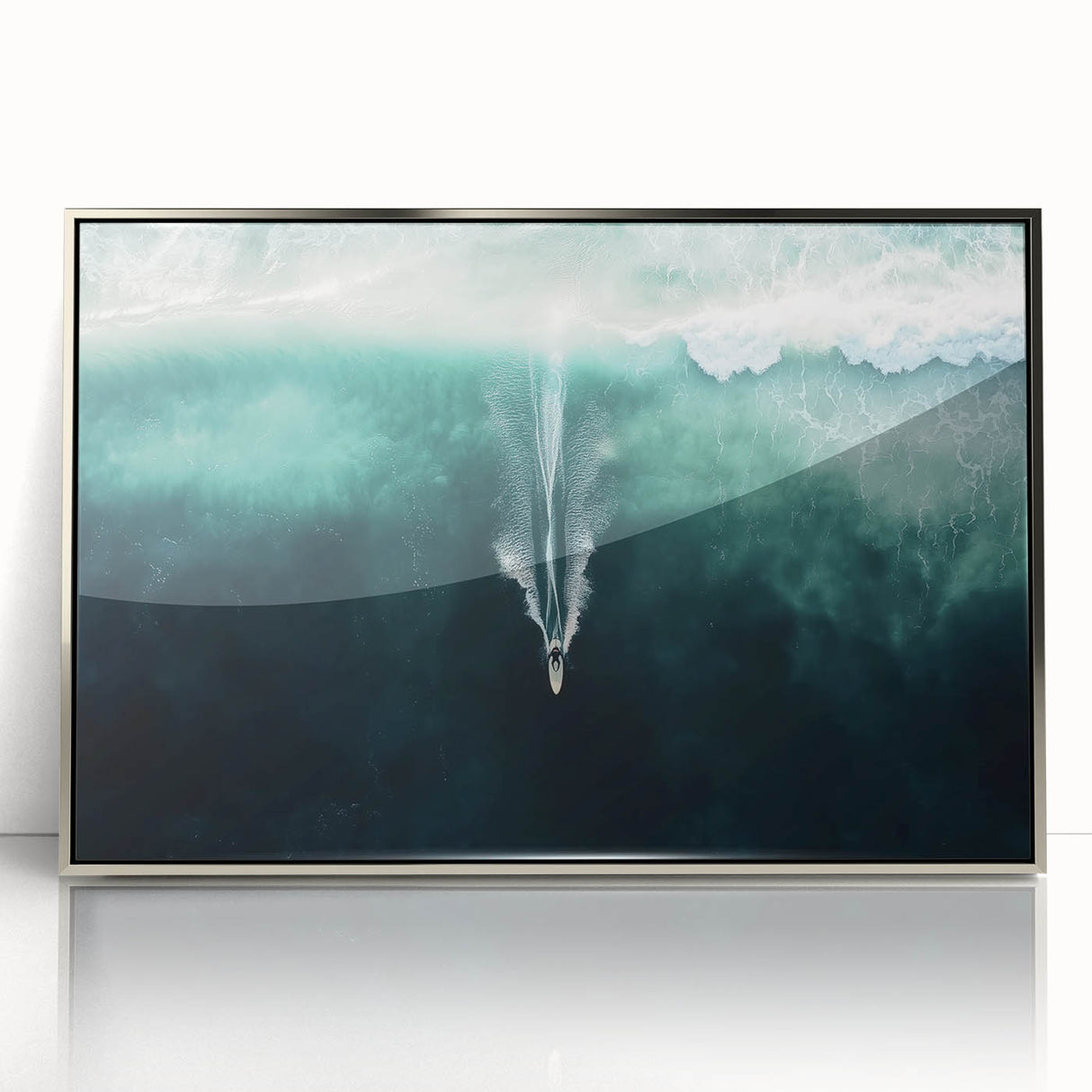 Framed acrylic artwork depicting a serene beach landscape with gentle waves and soft sand, accented by silver framing, ideal for coastal-themed decor.