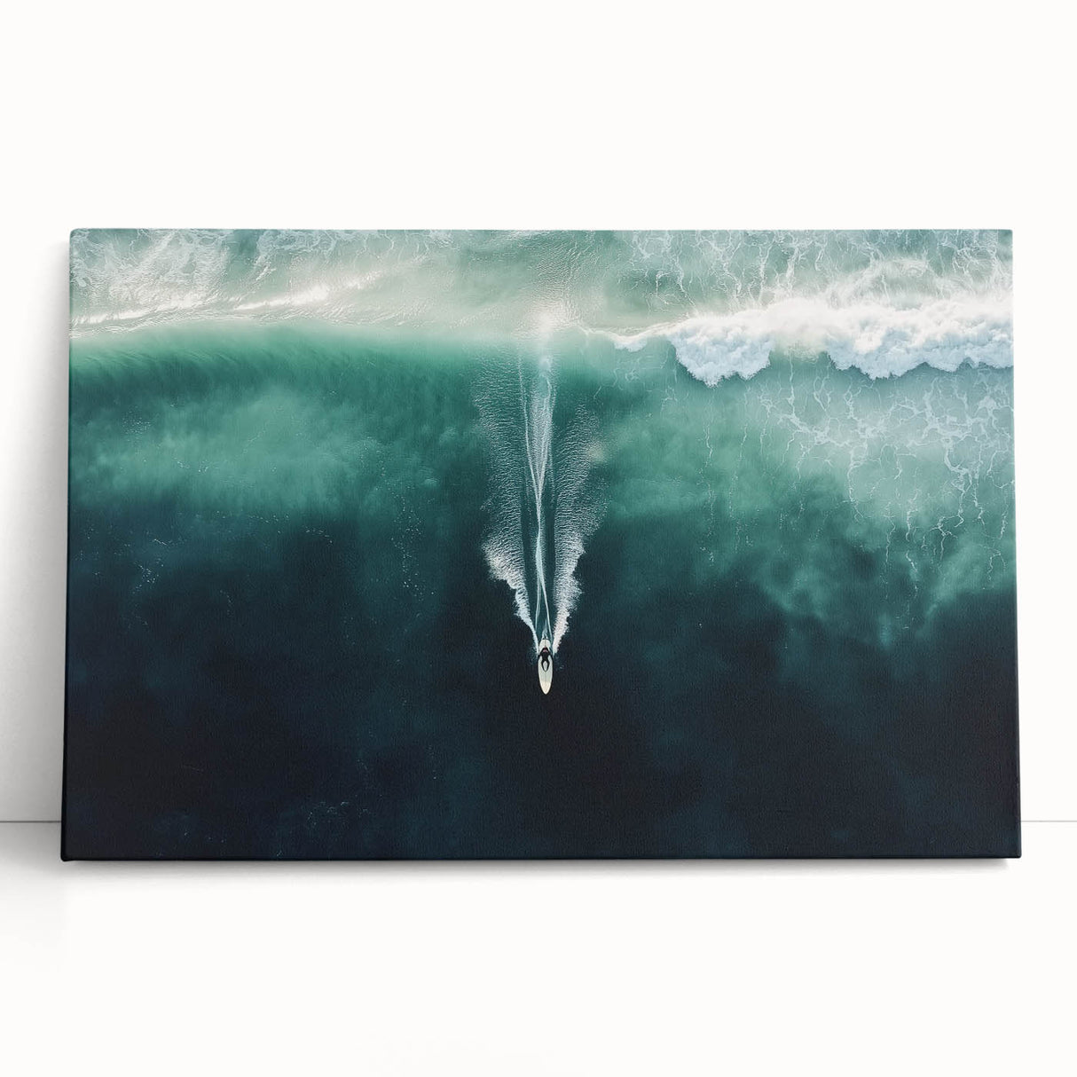 Stretched canvas artwork depicting a serene beach landscape with vibrant blue skies and gentle waves, perfect for coastal-themed decor in homes or offices.