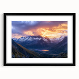 Framed landscape artwork showcasing dramatic cliffs in vibrant hues, set in a sleek black frame with a white mat, perfect for modern home decor.