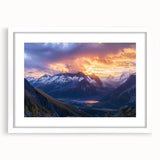 Framed landscape artwork showcasing a dramatic cliff scene with vibrant colors and deep blue skies, elegantly matted and presented in a white frame, perfect for home decor.