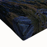 Close-up of a stretched canvas artwork depicting dramatic cliffs and vibrant landscapes, showcasing rich colors and intricate details, ideal for home decor.