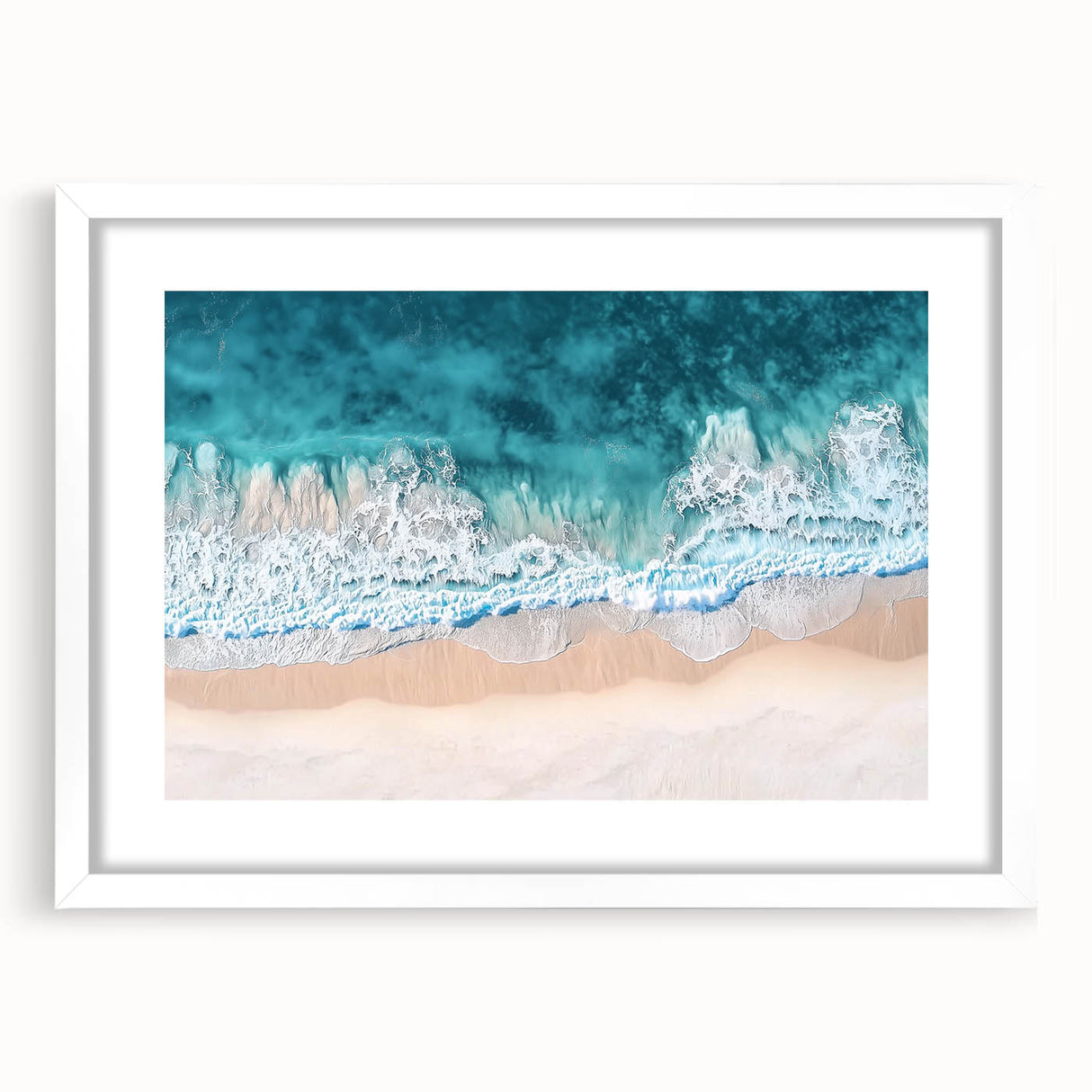 White-framed landscape artwork showcasing a serene beach scene with soft waves, vibrant blue skies, and gentle clouds, perfect for coastal-themed decor.