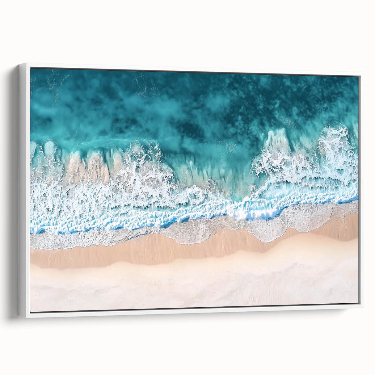Framed canvas artwork depicting a serene beach landscape, showcasing vibrant blues and soft whites, elegantly displayed with a sleek white frame, enhancing any coastal-themed decor.