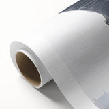 Rolled canvas showcasing a vibrant landscape bridge design, featuring rich colors and intricate details, packaged securely in a protective cardboard tube for safe shipping.