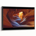 Framed canvas artwork showcasing a stunning landscape of canyons in rich earthy tones, presented in a sleek black frame, ideal for home decor enhancement.