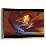 Framed canvas artwork showcasing a breathtaking landscape of canyons, with a sleek silver frame highlighting the natural beauty of the scene. Ideal for modern home decor.