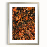 Textured abstract art print depicting fall foliage in earthy tones on a framed silver mat, ideal for bedroom decor.