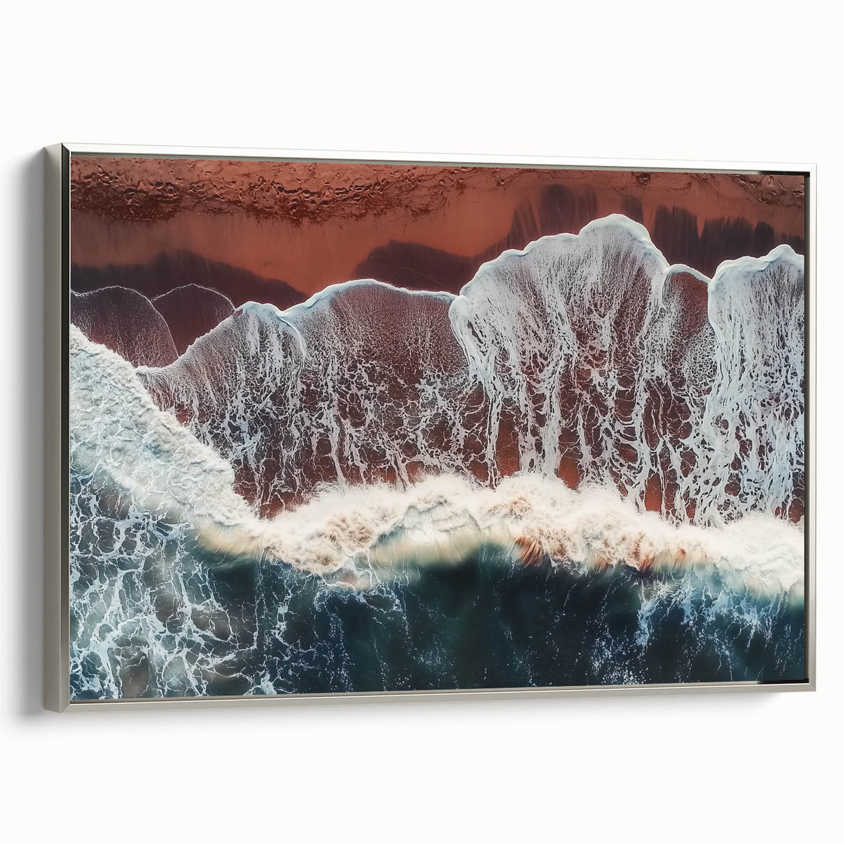 Framed landscape canvas artwork showcasing a serene beach scene with gentle waves, complemented by a sleek silver frame, perfect for coastal-themed decor.