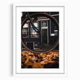 Abstract art print depicting fall foliage in warm orange and red tones on a framed white canvas, ideal for dining room decor.