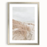 Textured abstract art print in silver frame, featuring swirling gray and white patterns, ideal for modern bedroom decor.