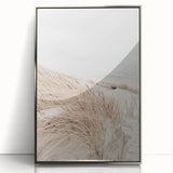 Mid-century modernist art featuring abstract shapes in pastel shades on a silver-framed acrylic print.