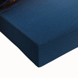 Close-up of a vibrant stretched canvas depicting a dramatic landscape with cliffs and rich colors, showcasing intricate details and textures, perfect for home decor.