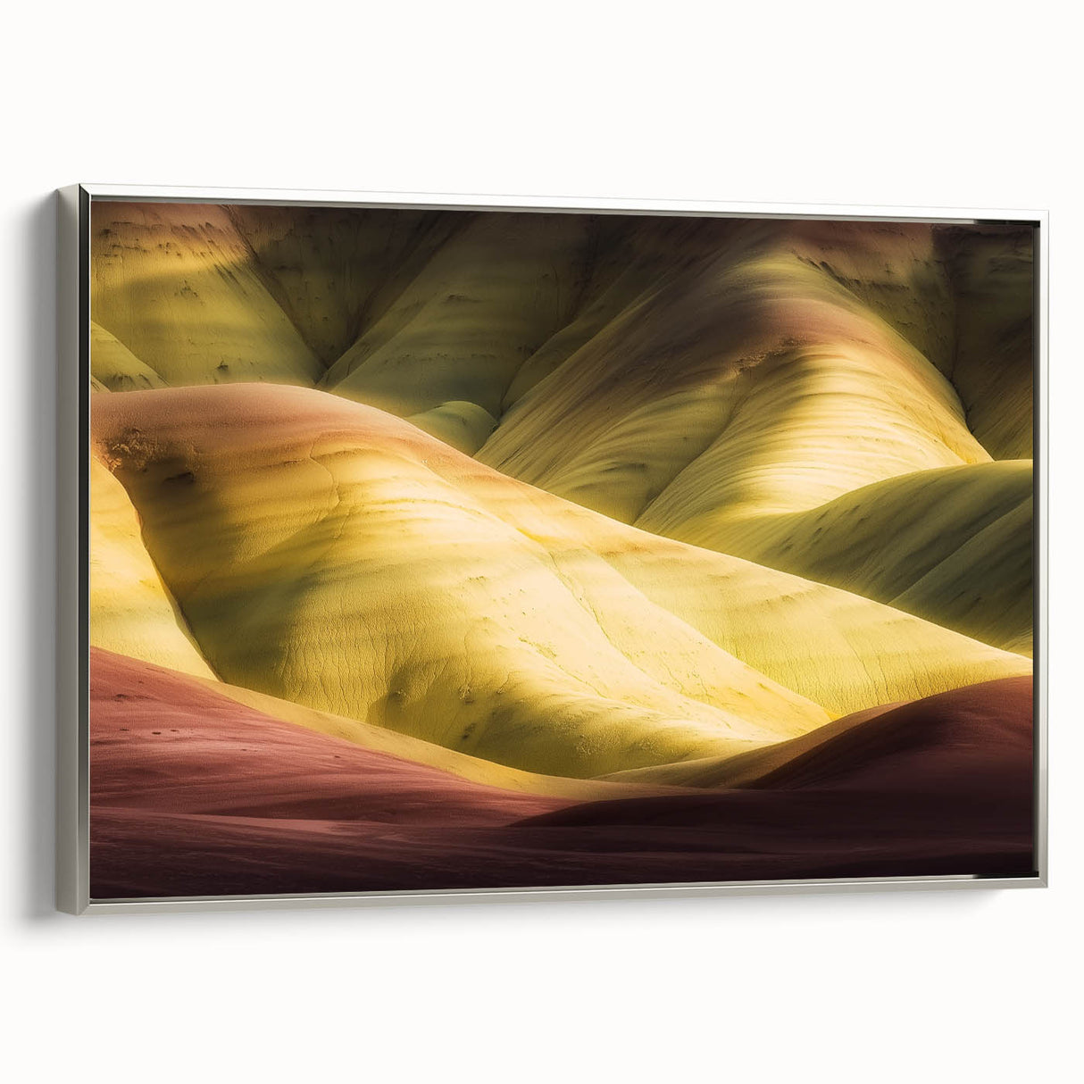 Framed canvas artwork showcasing a stunning landscape of canyons, featuring rich earth tones and intricate textures, displayed in a sleek silver frame. Perfect for enhancing modern home decor.