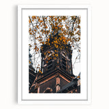 Abstract art print depicting autumnal trees in orange and red tones on a white framed canvas, ideal for dining room decor.