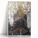 Art deco poster featuring a stylized fall scene in orange and brown tones, framed in white acrylic.