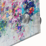 Close-up of a vibrant abstract splatter design on acrylic glass, showcasing a blend of bold colors, ideal for modern home decor or artistic displays.