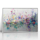 Framed acrylic artwork featuring vibrant abstract splatters in shades of blue, pink, and yellow, set against a sleek white background, perfect for modern home decor.