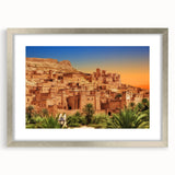 Abstract art print of a Moroccan landscape in muted earth tones, framed in silver, suitable for dining room decor.