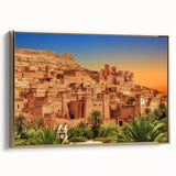 Framed canvas landscape art painting of a Moroccan scenery in muted gold and black tones.