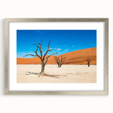 Abstract art print of Namibian landscape in muted earth tones, framed in silver, suitable for dining room decor.