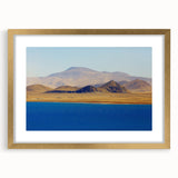 Extra large framed textured abstract art print depicting a muted gold and blue Tibetan landscape.