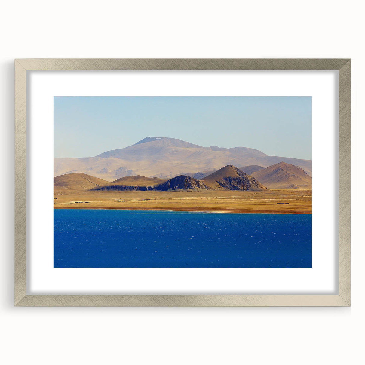 Textured abstract art print depicting a Tibetan landscape in muted earth tones on a framed silver mat, ideal for bedroom art.
