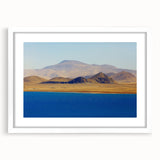 Abstract art print depicting a Tibetan landscape in muted earth tones on a framed white canvas.