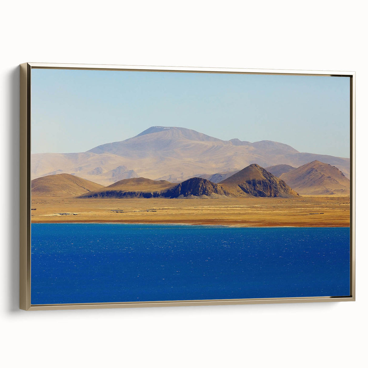 Landscape painting of Tibetan scenery in muted gold and black tones on a framed canvas, suitable for bedroom wall art.