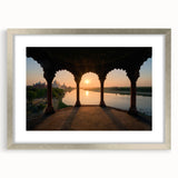Textured abstract art print depicting a serene Indian landscape in earthy tones, framed in silver, ideal for bedroom decor.