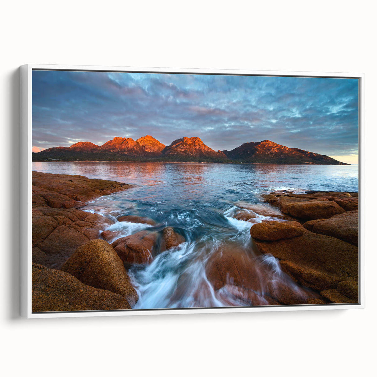 Framed canvas depicting a vintage-style landscape painting of Tasmania, featuring vibrant colors on a black background.