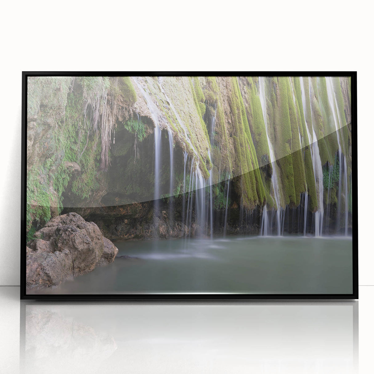 Large abstract wall art depicting a Caribbean landscape in muted blue and green tones, framed in black acrylic.