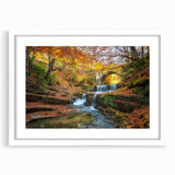 Textured abstract art print of a European scenery in muted earth tones, framed with a white mat, suitable for bedroom decor.