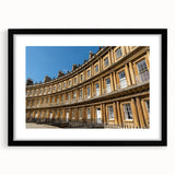 Extra large abstract art print of a colorful European scenery, displayed in a black frame with mat.