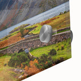 Mid-century modernist acrylic glass wall art depicting abstract Cumbrian landscape in muted earth tones.