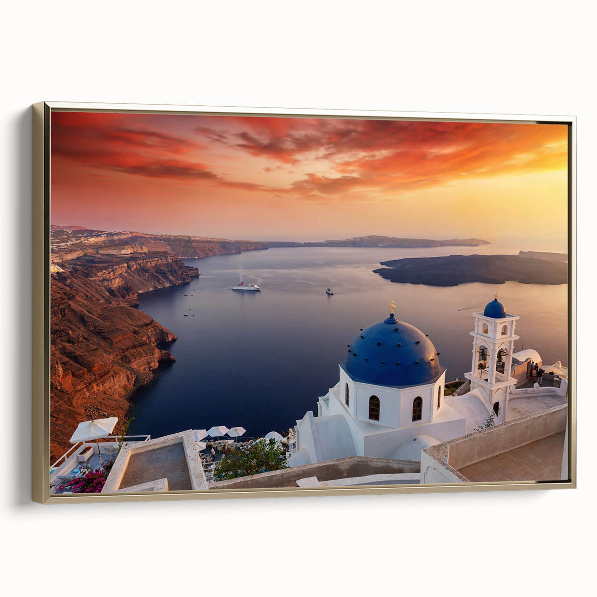 Framed canvas wall art featuring a vintage-style landscape painting of Santorini, Greece with muted blue and white tones.
