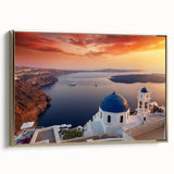 Framed canvas wall art featuring a vintage-style landscape painting of Santorini, Greece with muted blue and white tones.