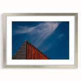 Extra large abstract art print of a European scenery in muted earth tones, displayed in a silver frame with mat.