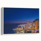 Vintage poster art of Monaco scenery on a framed canvas, featuring vibrant colors against a black background.