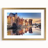 Abstract art print of European scenery in muted green and blue tones, framed in gold, ideal for dining room decor.