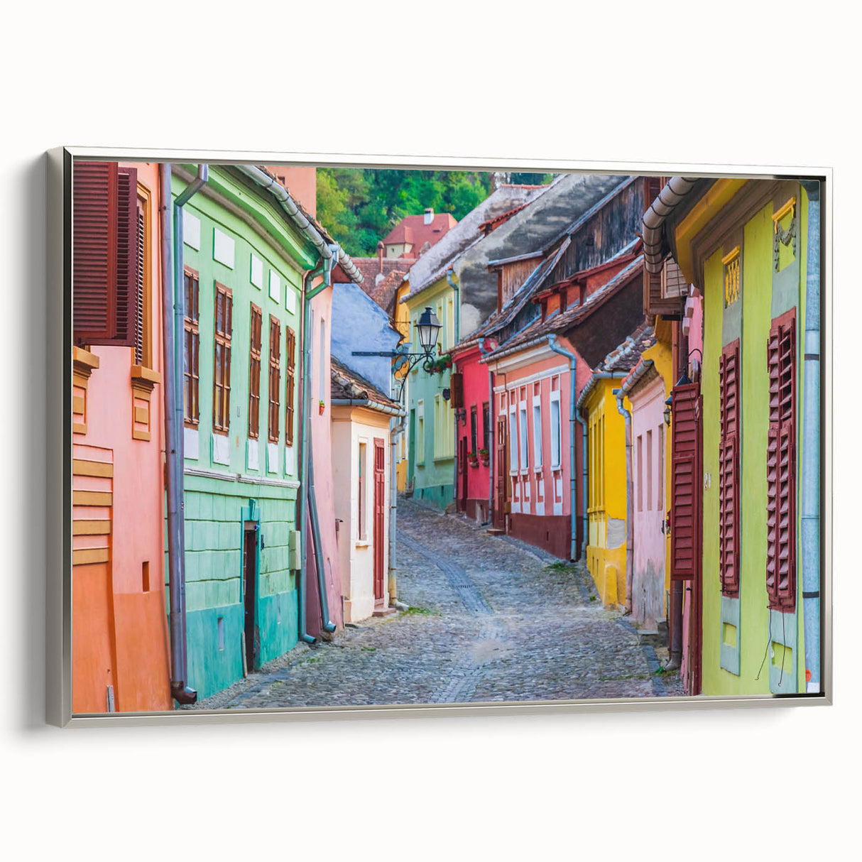 Framed canvas featuring a vintage-style Romanian landscape with colorful art and black borders, ideal for living room decor.