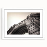 Textured abstract art print of a European cityscape in muted earth tones on a framed white canvas.