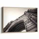 Framed canvas featuring a vintage poster art of Barcelona landscape in muted gold and black tones.