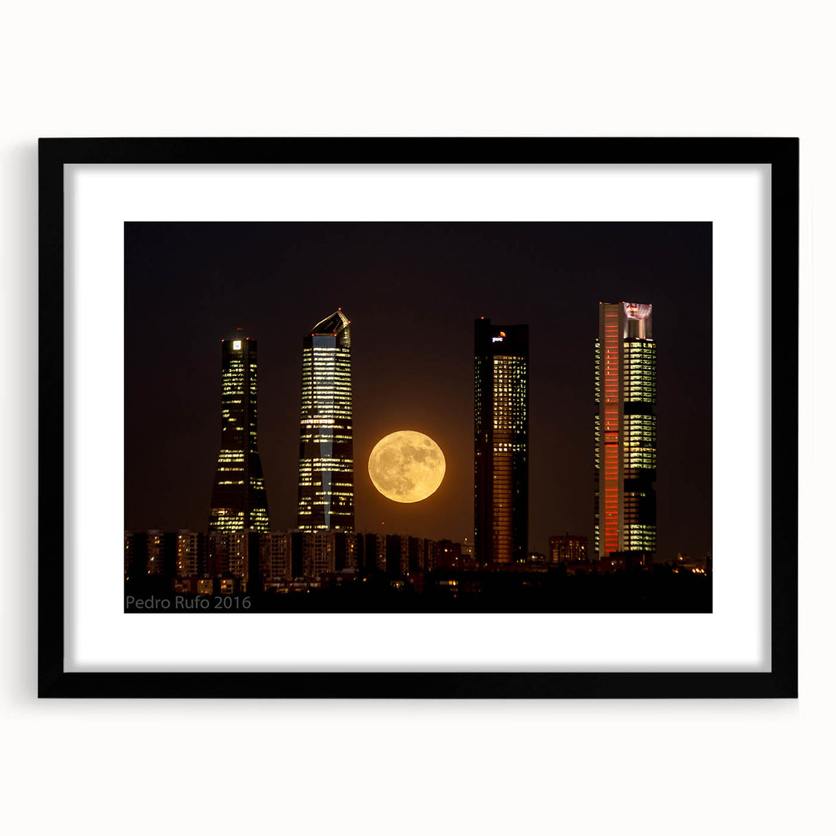 Extra large abstract art print of Madrid scenery in vibrant colors on a black framed canvas, ideal for living room decor.