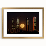 Extra large wall art of a textured abstract print depicting Madrid's cityscape in muted earth tones, framed in gold.
