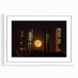 Abstract art print depicting Madrid's skyline in muted gray and blue tones on a framed white mat.