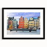Extra large abstract art print of a vibrant, colorful European scenery on a textured canvas, framed in black.