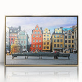 Large art print of a serene Swedish landscape in soft pastel colors on a gold-framed acrylic.